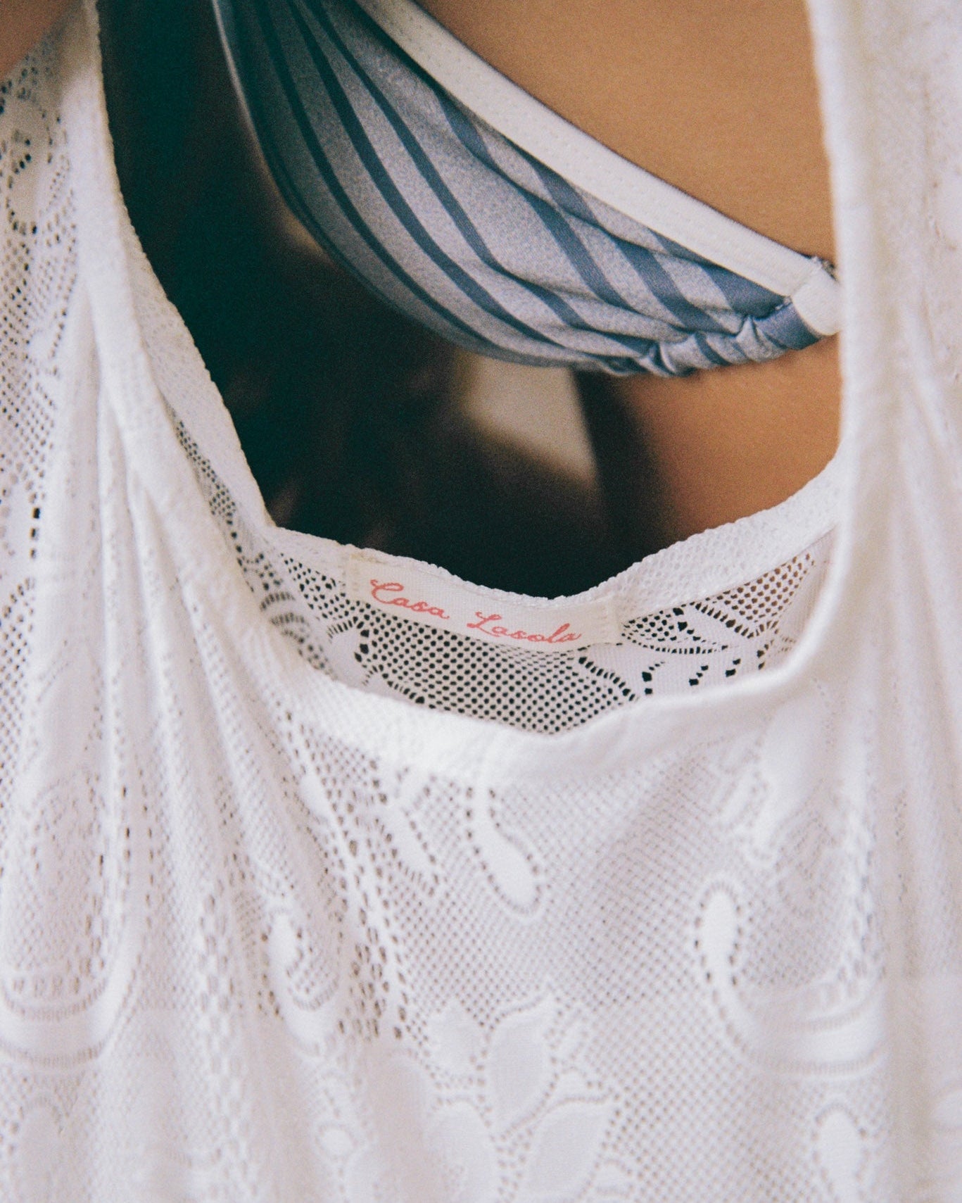 Close-up of a white lace bag with a casa lasola label.